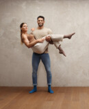 Man carrying woman in his arms, both wearing Juzo Intenso stockings