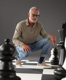 Man and woman in Juzo Dynamic stockings standing on a large chessboard