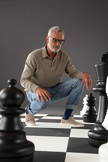 Man and woman in Juzo Dynamic stockings standing on a large chessboard